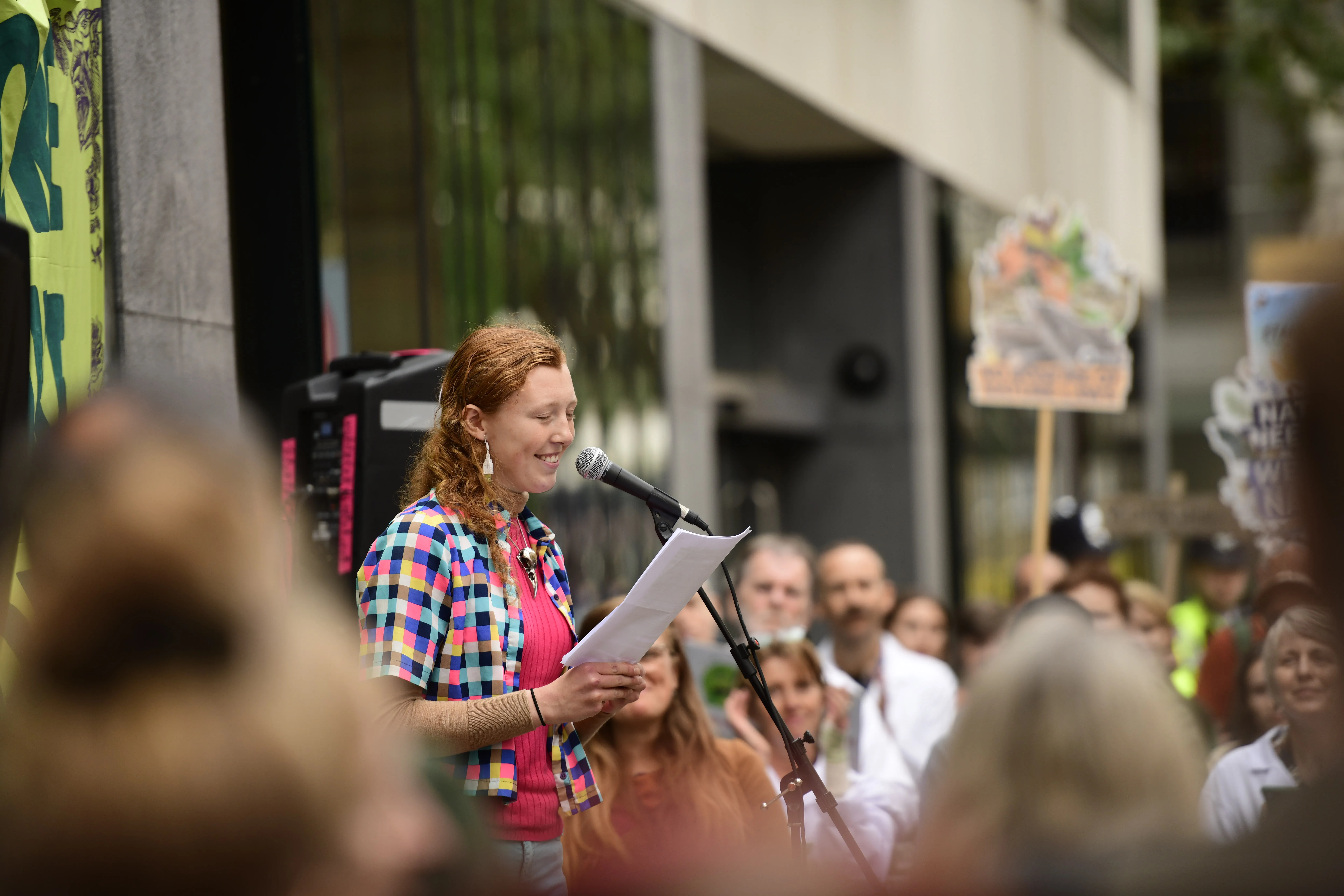 A youth council member speaks in front of a crowd at an event.