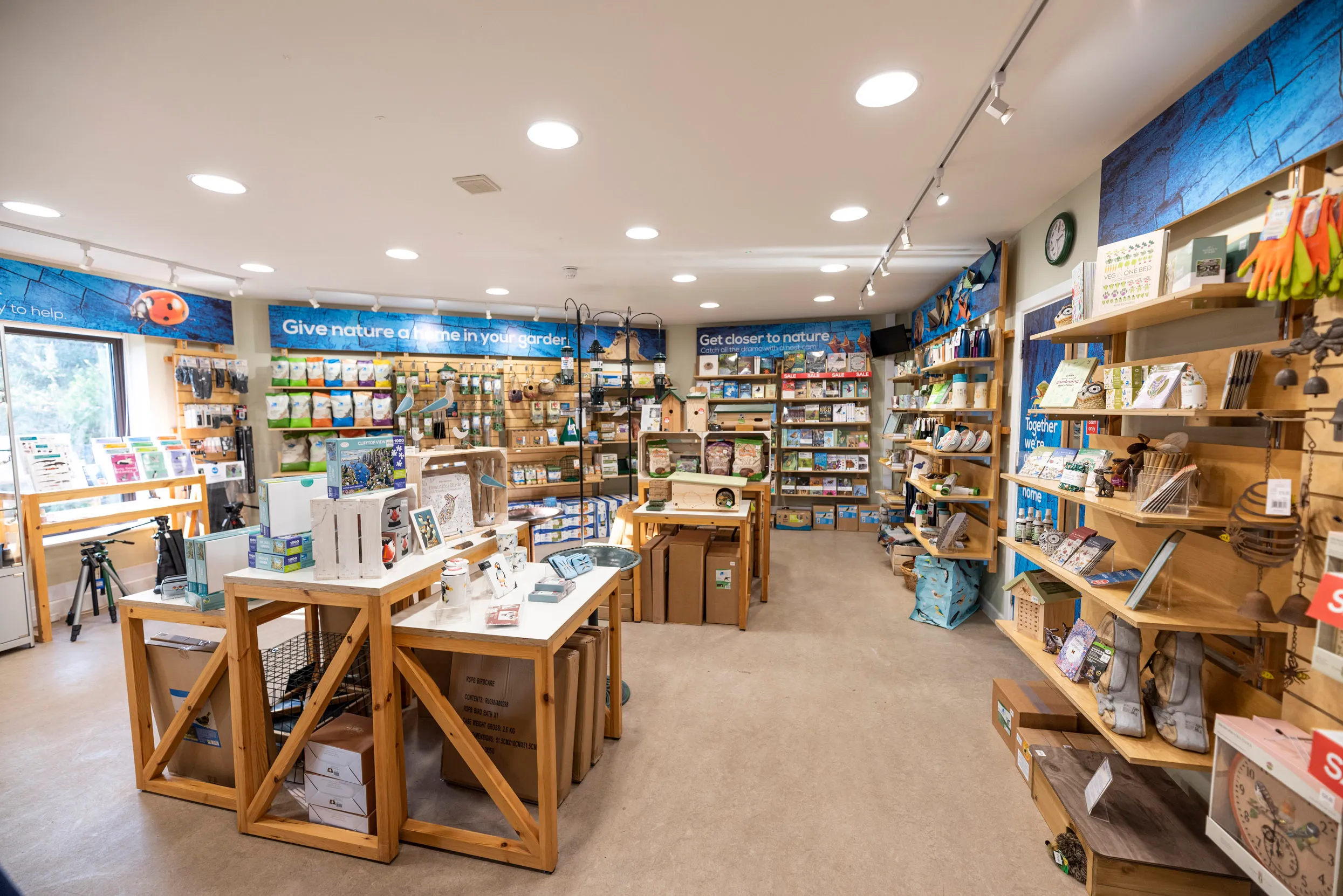 The view of the inside of an RSPB shop, filled with wooden displays.