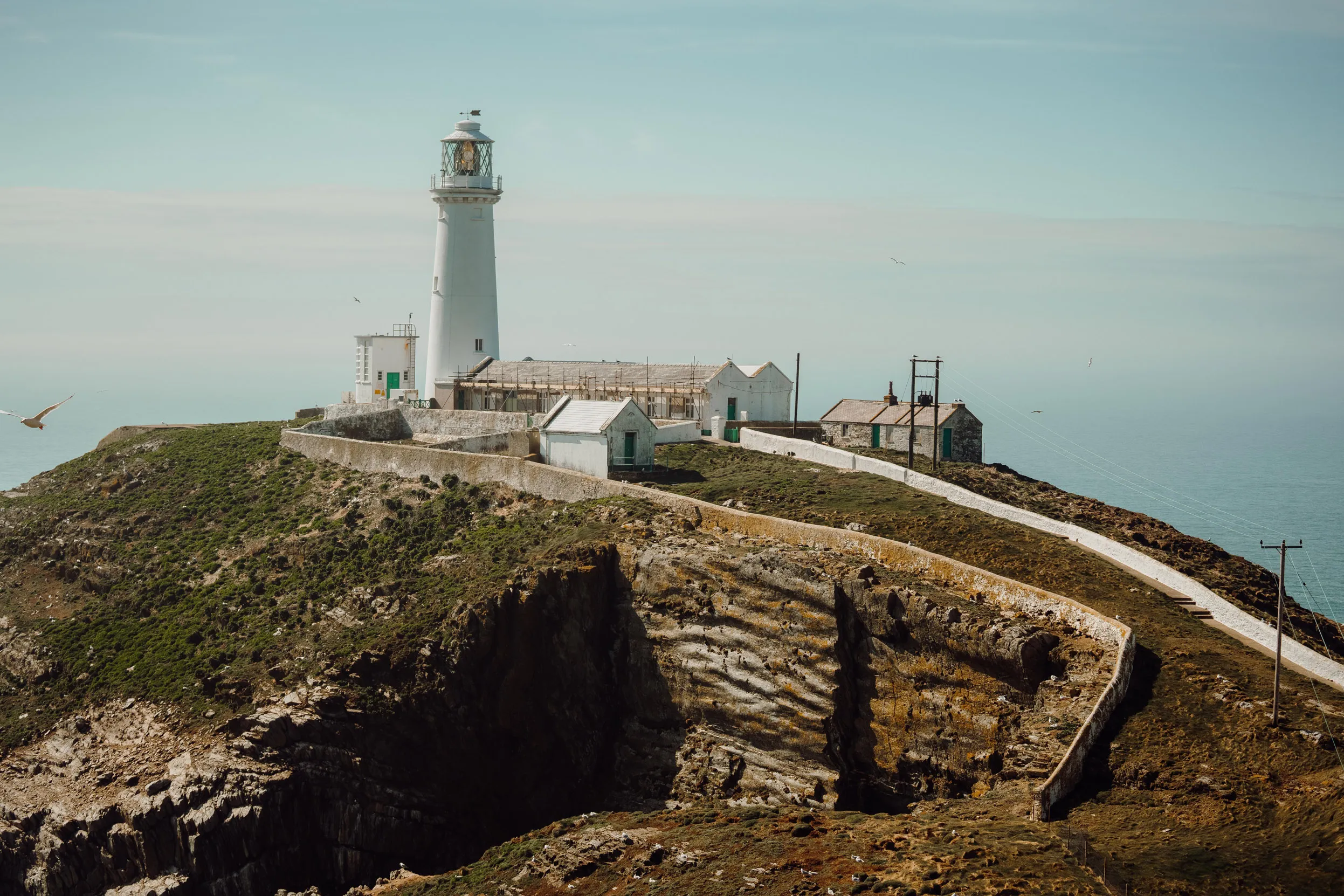 South Stack lighthouse against a blue ocean.